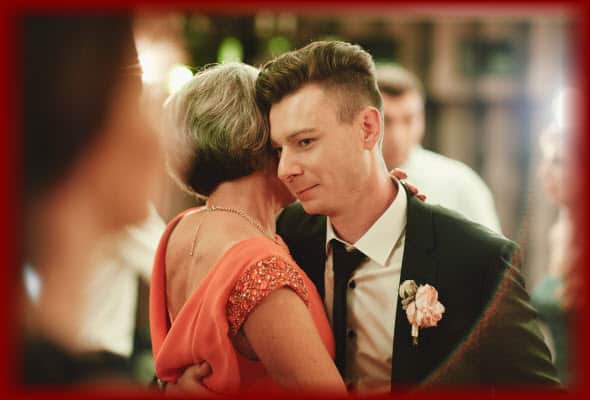 Happy Stylish Groom and his Proud Mother having a wonderful time dancing their "Mother Son Dance" at his wedding