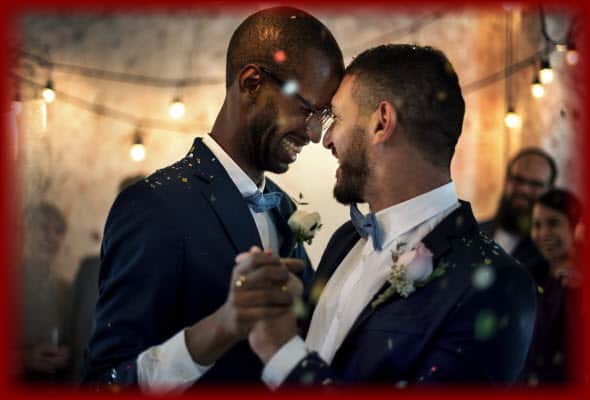 Newlywed gay couple having a wonderful time dancing their First Dance at their wedding reception