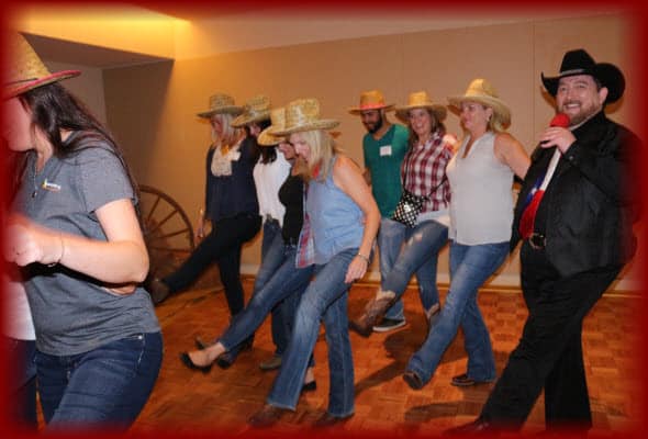 Tony New teaching a group of employees having great fun at their company sponsored dance party lessons